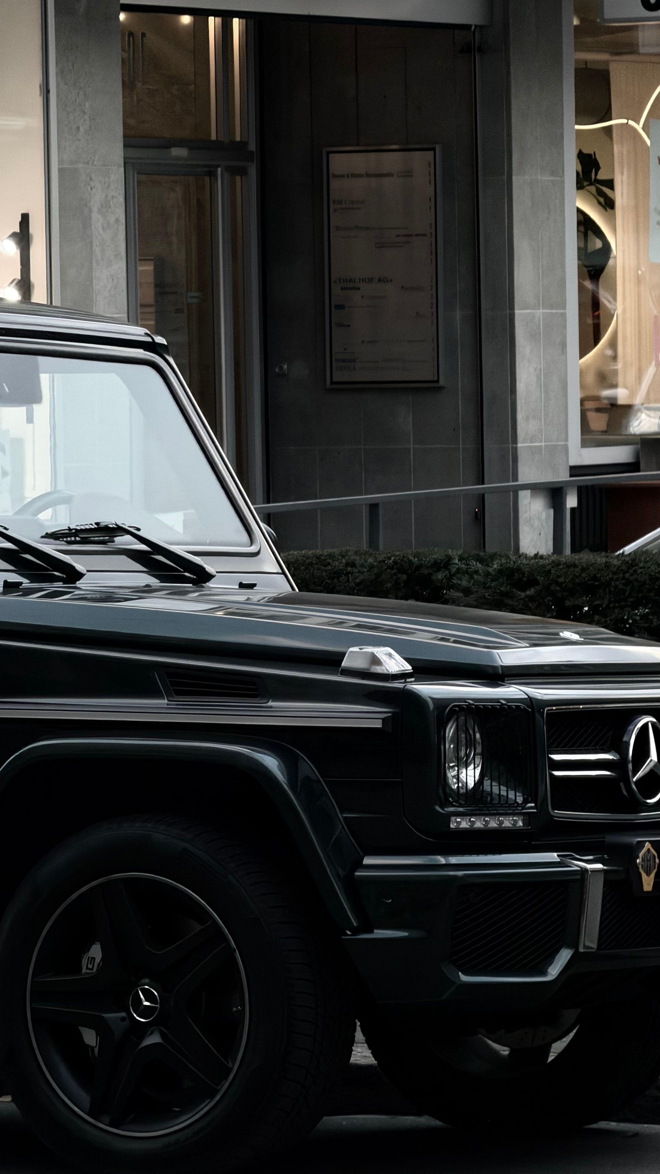 Black executive SUV in an urban setting