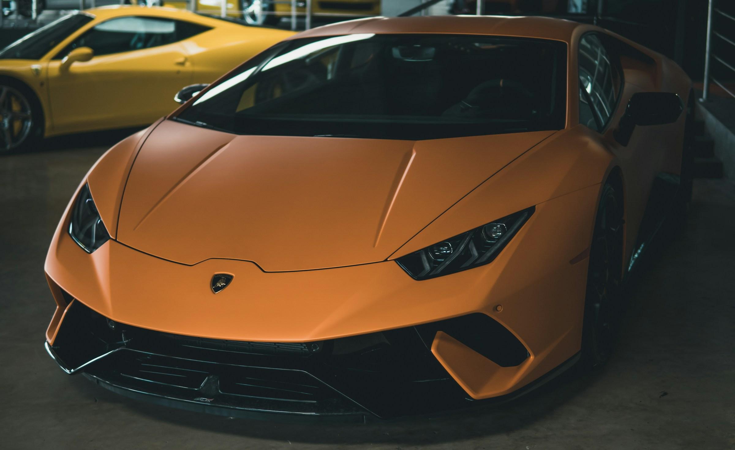 Orange Lamborghini Huracan photographed in a showroom
