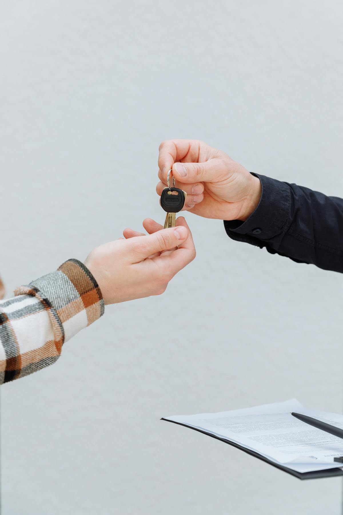 Rental vehicle key handoff with paperwork